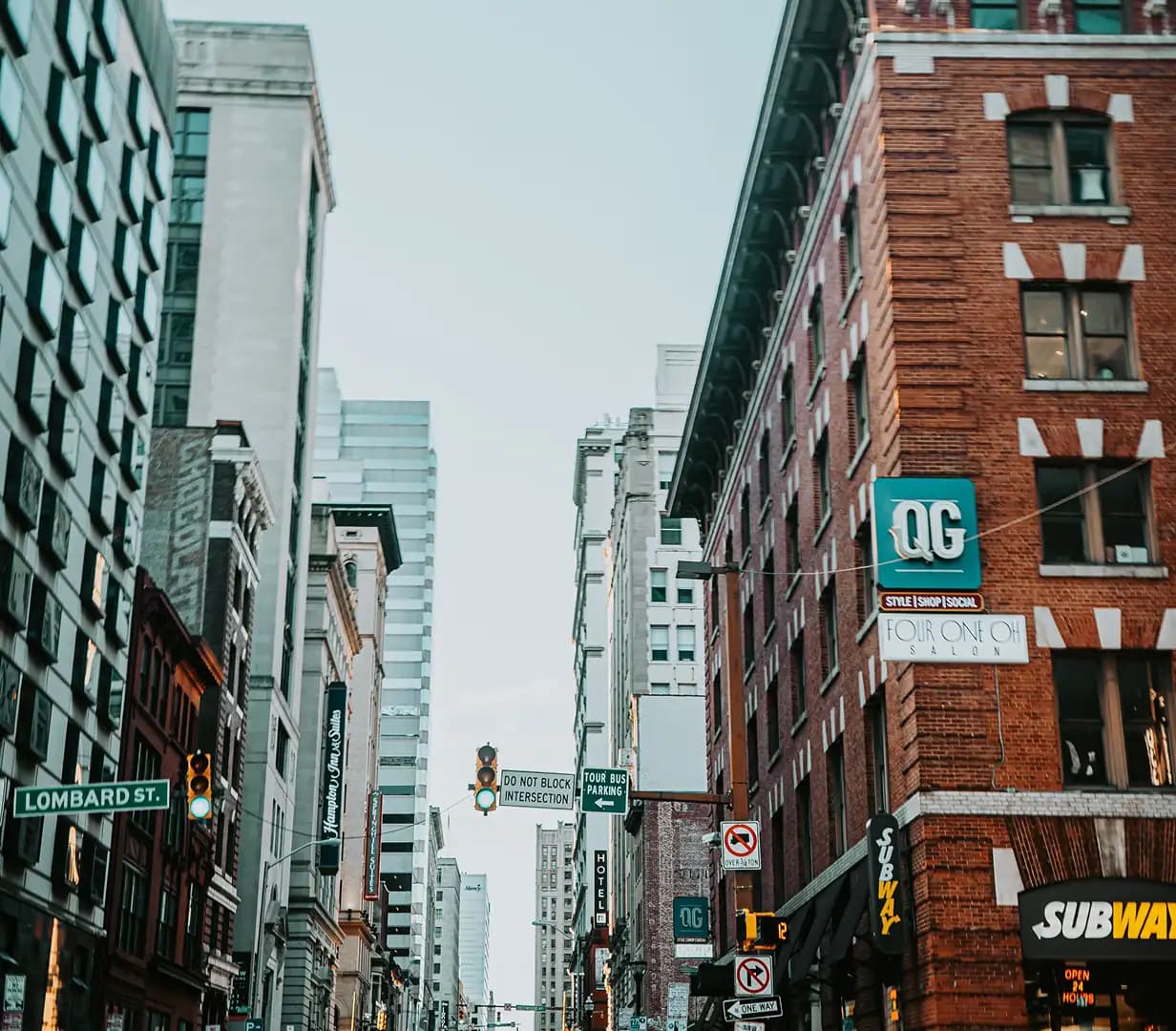 Narrow downtown Baltimore street lined with brick row buildings on Lombard Street