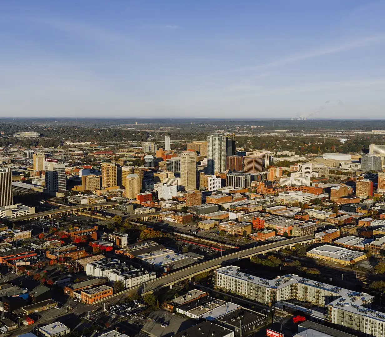 Aerial view of downtown Birmingham, Alabama skyline in autumn, a charter bus staging area