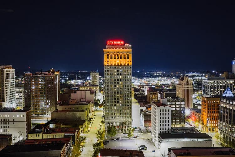 City Federal Building and downtown Birmingham, Alabama skyline at night, a charter bus pickup area