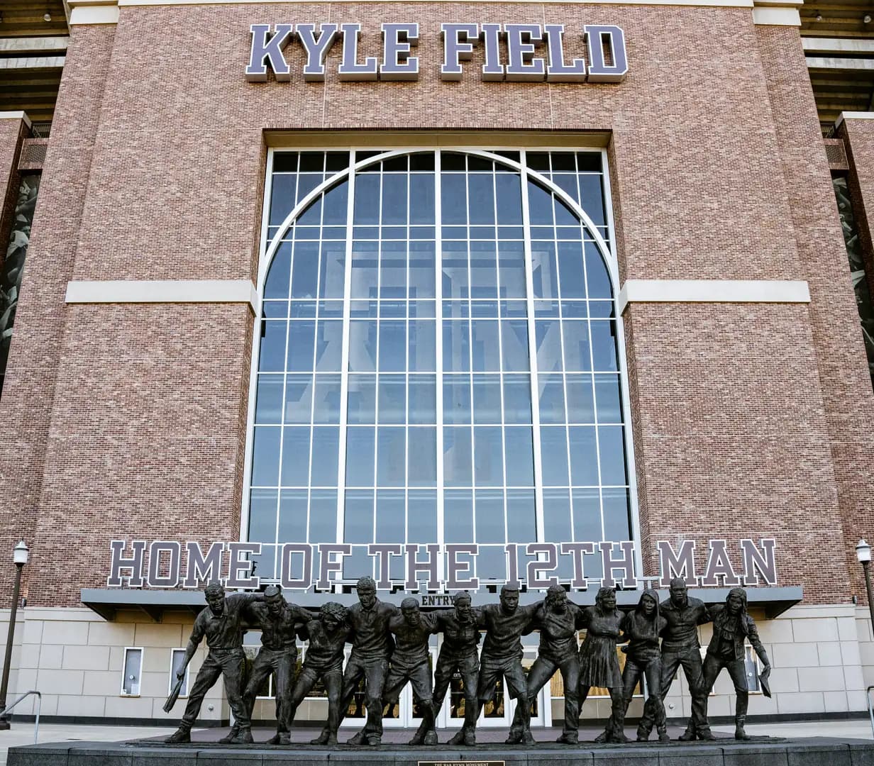 Kyle Field entrance with Home of the 12th Man lettering and the War Hymn Monument at Texas A&M in College Station, Texas