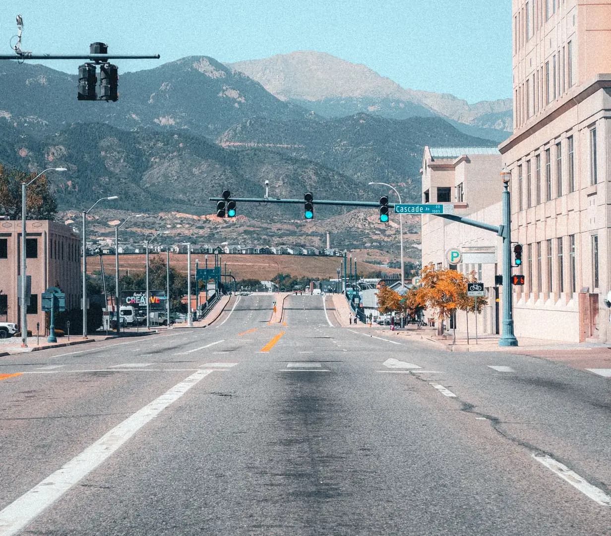Wide downtown street at Cascade Avenue leading toward Pikes Peak and the Front Range in Colorado Springs, Colorado