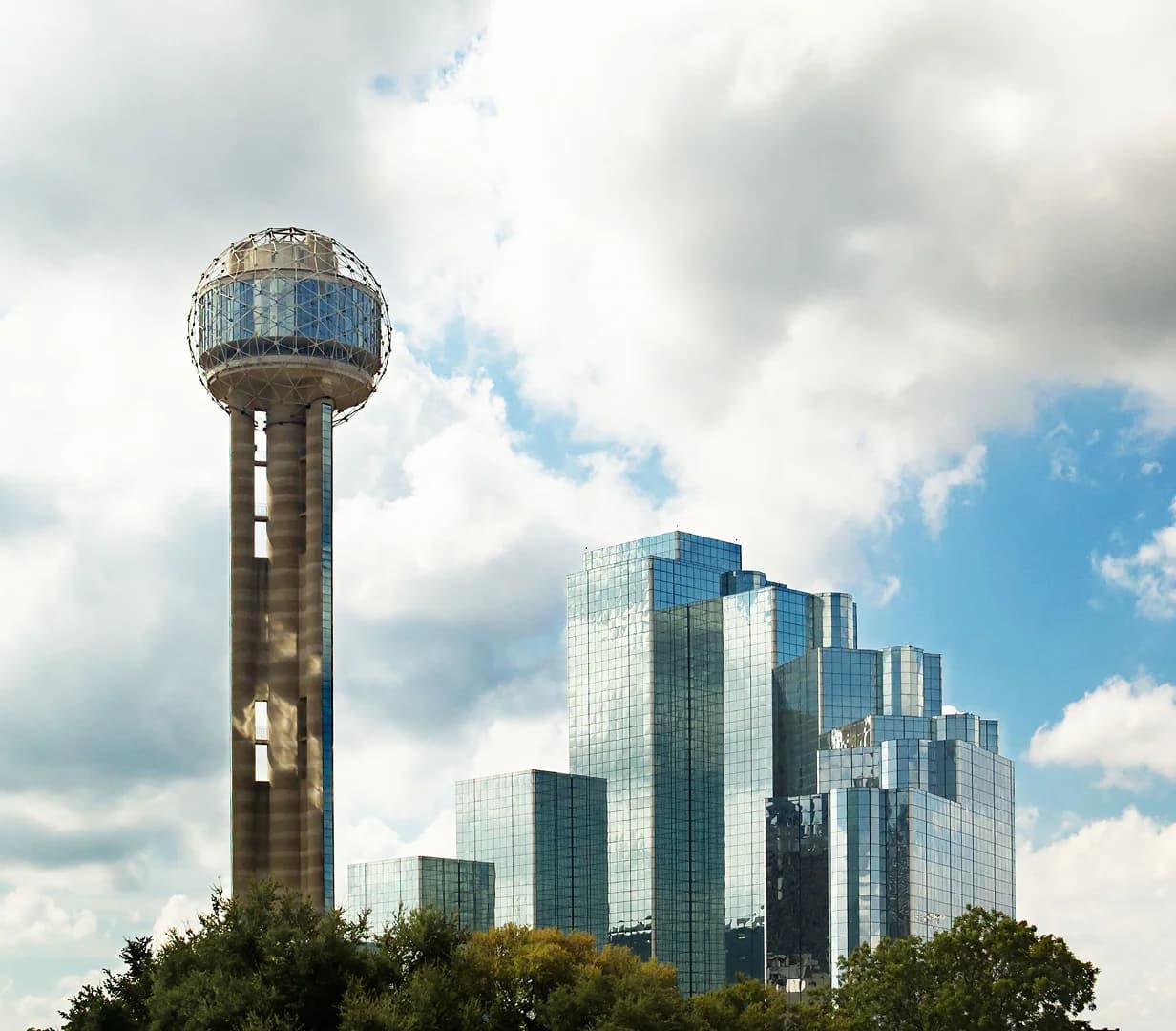 Reunion Tower beside the Hyatt Regency on the downtown Dallas skyline, a common pickup area for charter bus groups