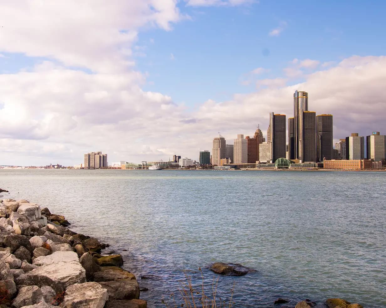 The Detroit skyline along the riverfront, anchored by the cylindrical towers of the Renaissance Center