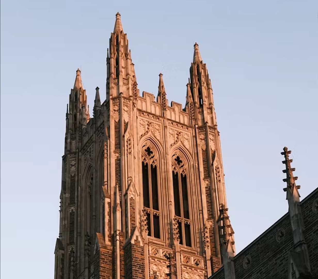 Gothic tower of Duke Chapel at golden hour in Durham, North Carolina, on the campus-visit route for charter bus groups