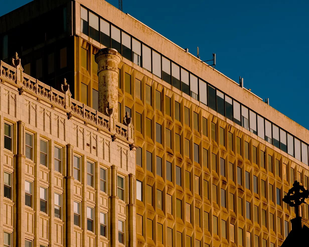Golden hour light on downtown Jackson, Mississippi building facades, a charter bus Capitol-complex pickup point