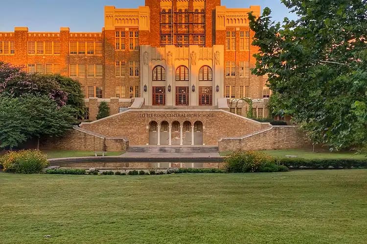 Historic facade of Little Rock Central High School at golden hour, a charter bus field-trip destination