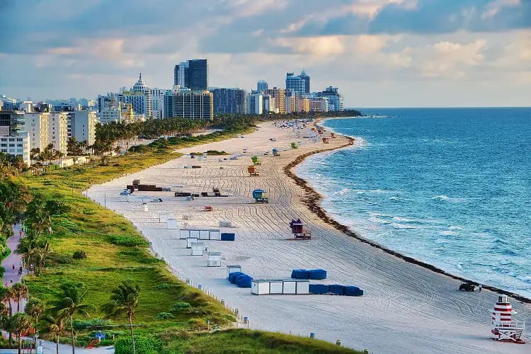 Aerial view of South Beach's white sand and the Miami, Florida skyline, a hotel pickup area for charter bus groups