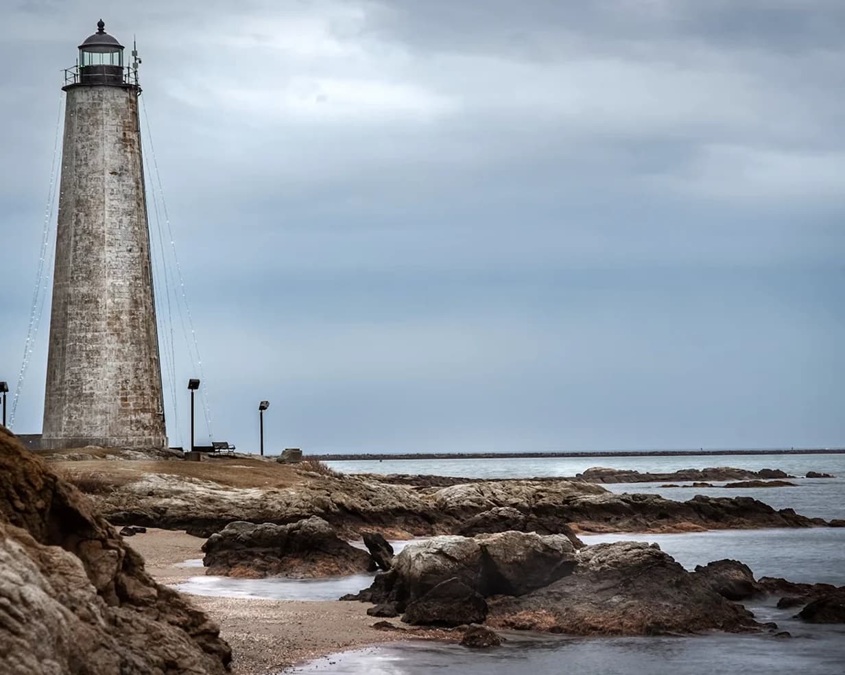 Five Mile Point Lighthouse on the rocky New Haven, Connecticut shoreline, a day-trip stop for charter bus groups