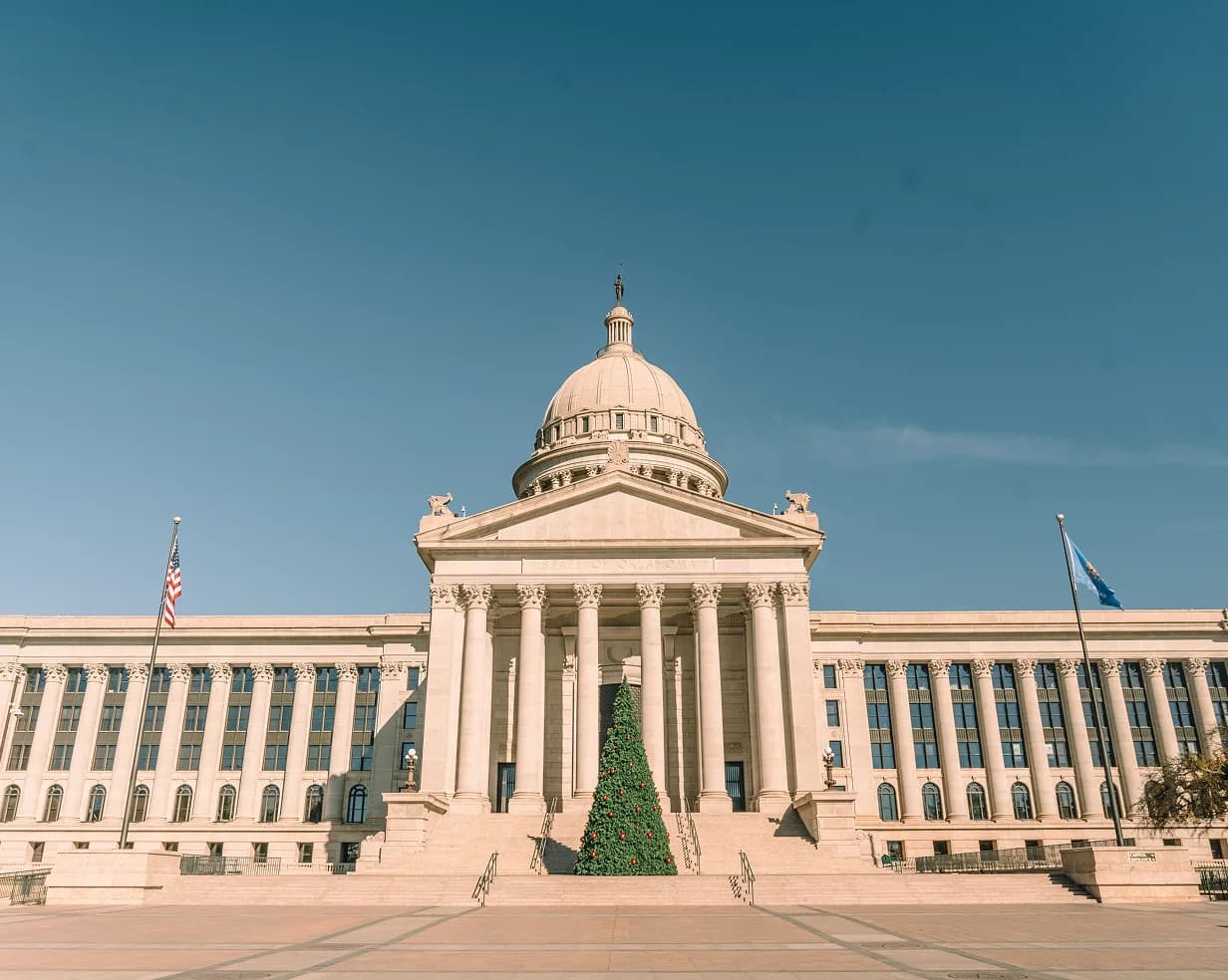 Oklahoma State Capitol dome and columns with a Christmas tree in Oklahoma City, Oklahoma, a charter bus lobby-day stop