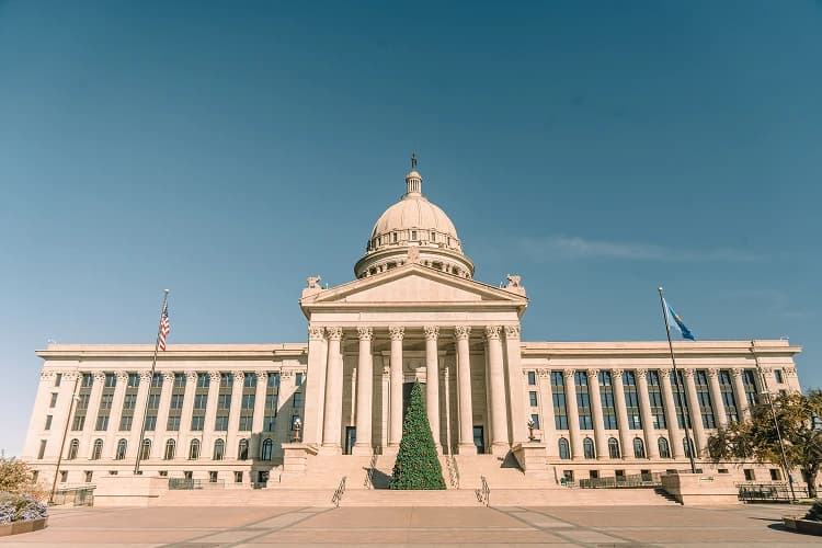 Oklahoma State Capitol dome and columns with a Christmas tree in Oklahoma City, Oklahoma, a charter bus lobby-day stop