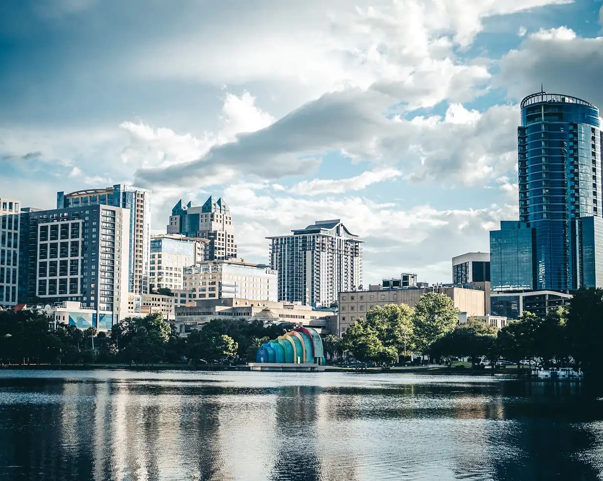 The colorful bandshell at Lake Eola Park with the downtown Orlando skyline behind it