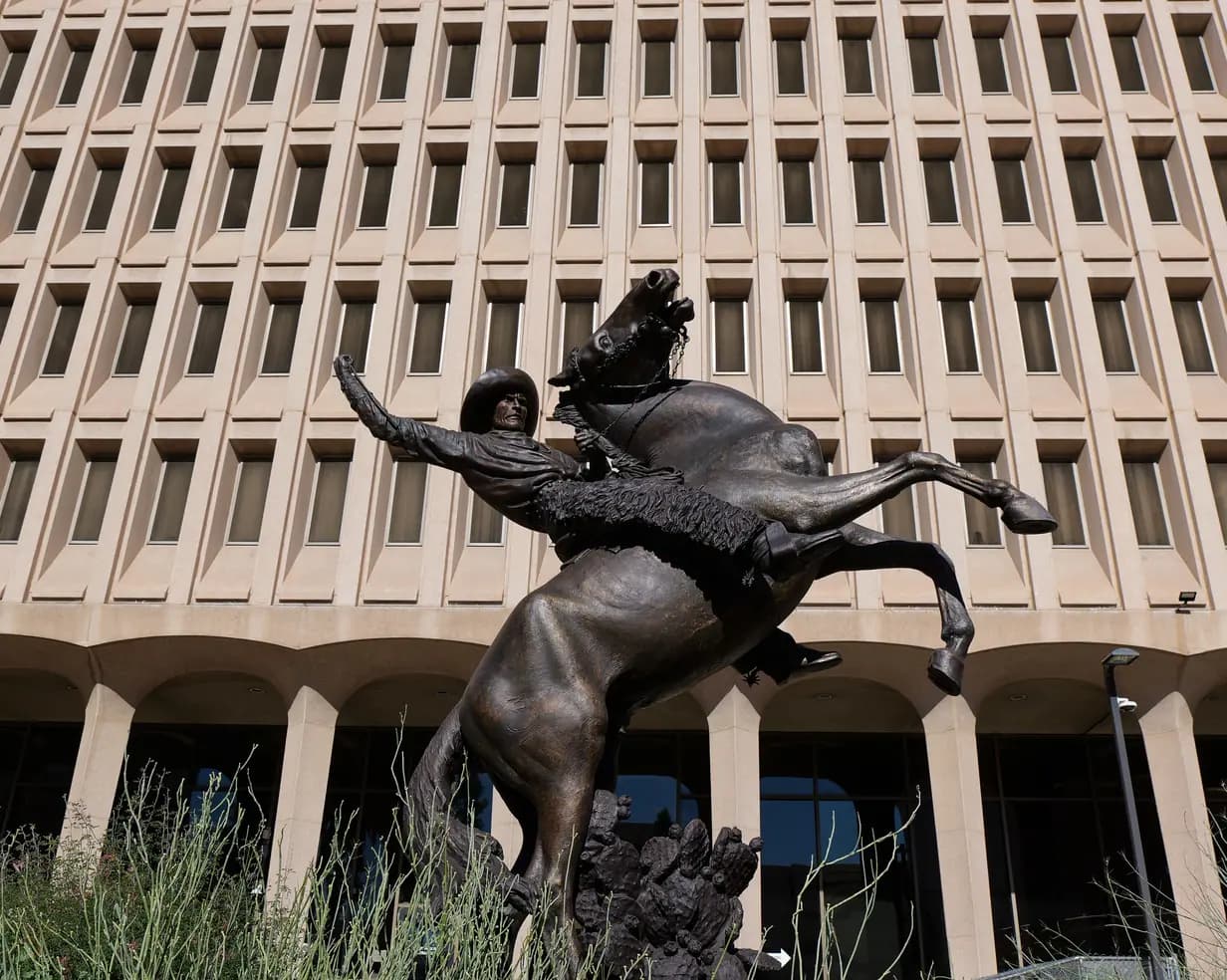 Bronze Lariat Cowboy sculpture of a rider on a bucking horse in front of a downtown office building in Phoenix, Arizona