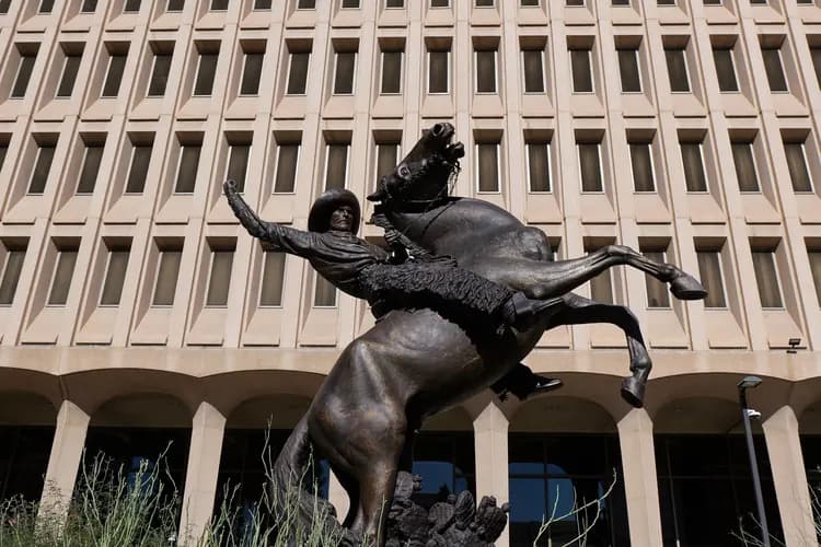 Bronze Lariat Cowboy sculpture of a rider on a bucking horse in front of a downtown office building in Phoenix, Arizona