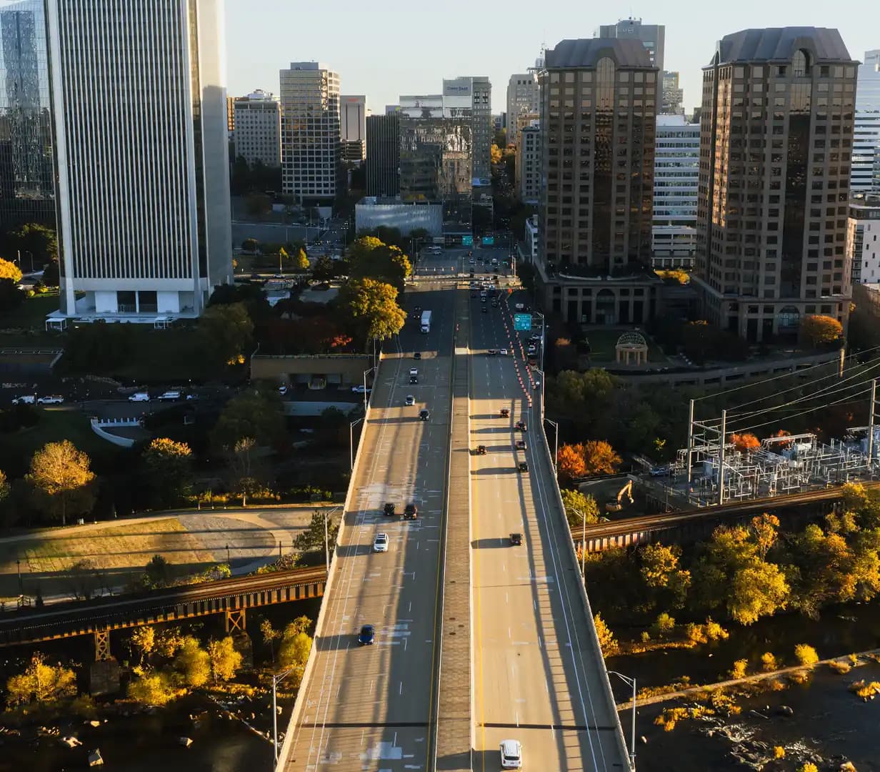 Aerial view of downtown Richmond in autumn with highway lanes and a river bridge crossing