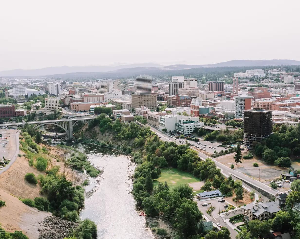 Aerial view of downtown Spokane, Washington, with the Spokane River, the Monroe Street Bridge and Riverfront Park
