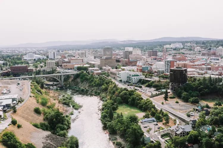 Aerial view of downtown Spokane, Washington, with the Spokane River, the Monroe Street Bridge and Riverfront Park