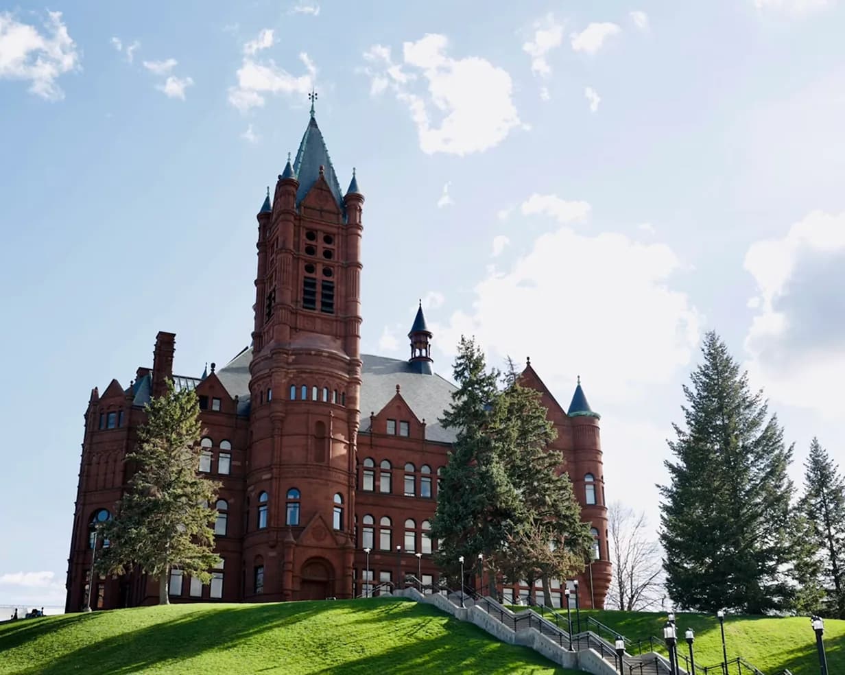 Crouse College's Romanesque tower on a green hillside at Syracuse University in Syracuse, New York, on the campus-visit route for charter bus groups