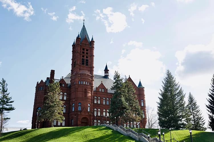 Crouse College's Romanesque tower on a green hillside at Syracuse University in Syracuse, New York, on the campus-visit route for charter bus groups