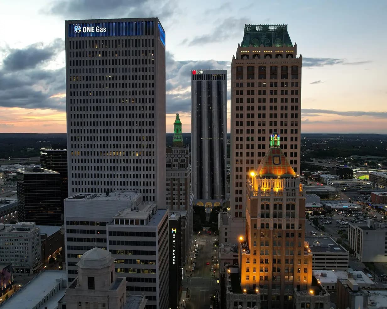 Downtown Tulsa, Oklahoma Art Deco towers at dusk, where charter bus groups stage for BOK Center events