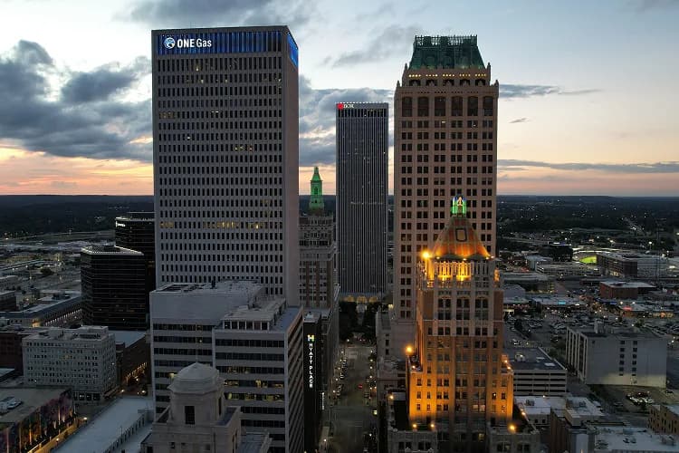 Downtown Tulsa, Oklahoma Art Deco towers at dusk, where charter bus groups stage for BOK Center events
