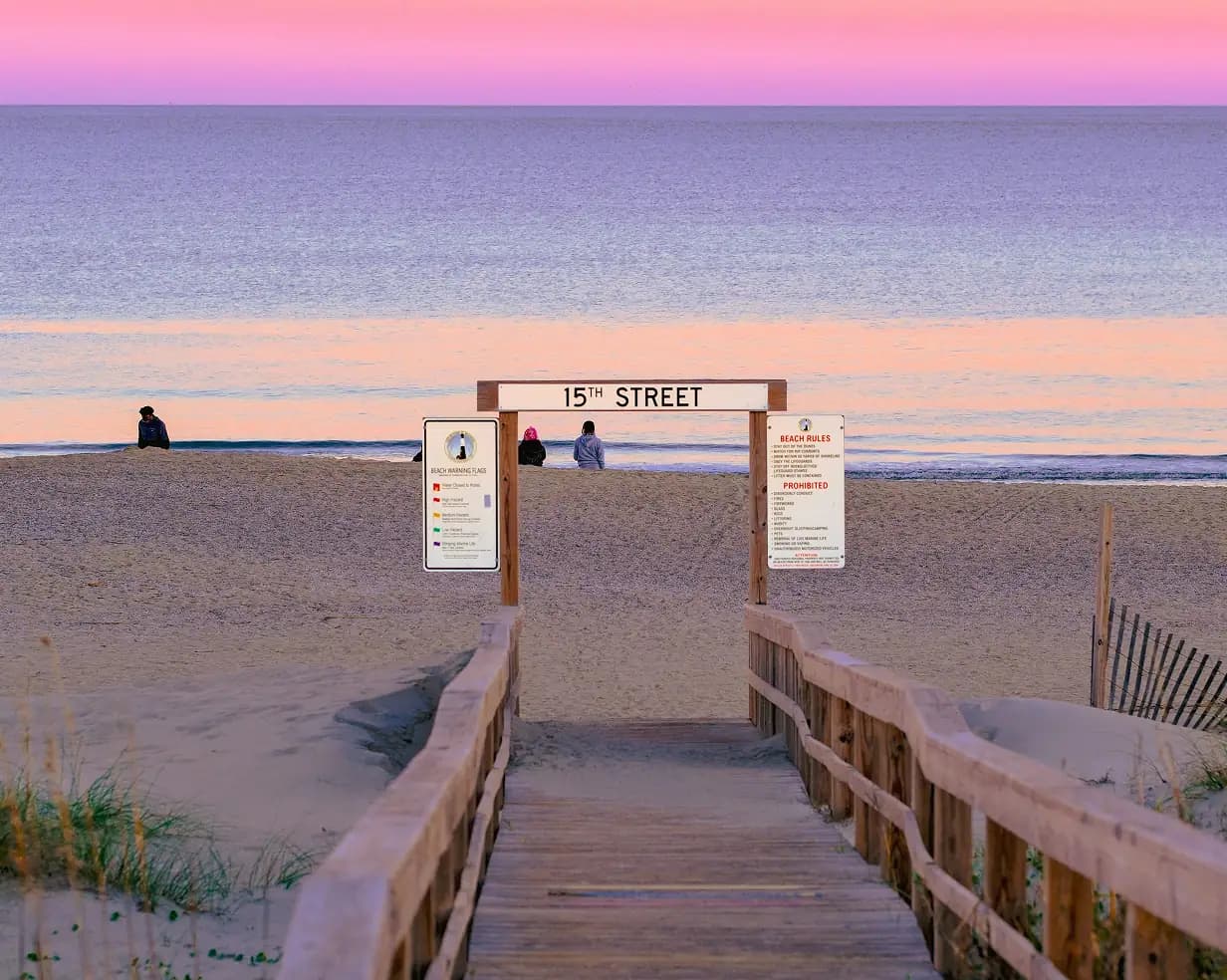 Golden-hour light along the Virginia Beach Boardwalk with the Atlantic Ocean beyond