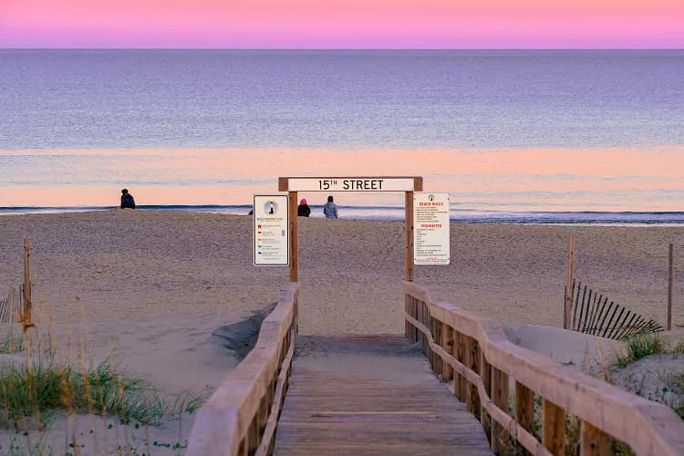 Golden-hour light along the Virginia Beach Boardwalk with the Atlantic Ocean beyond
