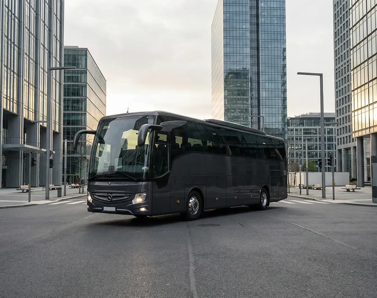 40 passenger black coach bus rental in urban downtown.