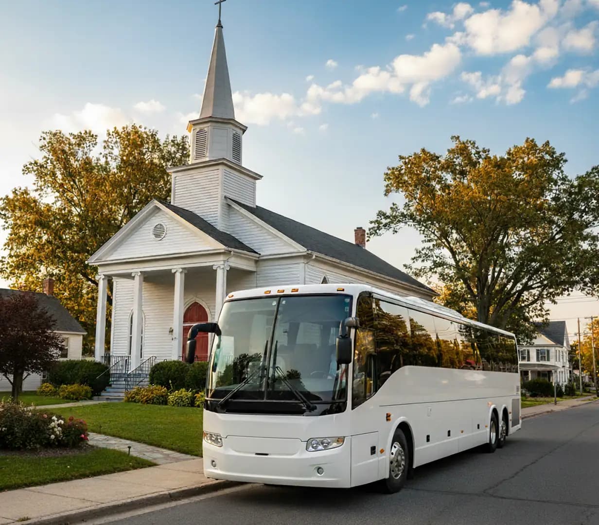 Church bus outside white chapel.
