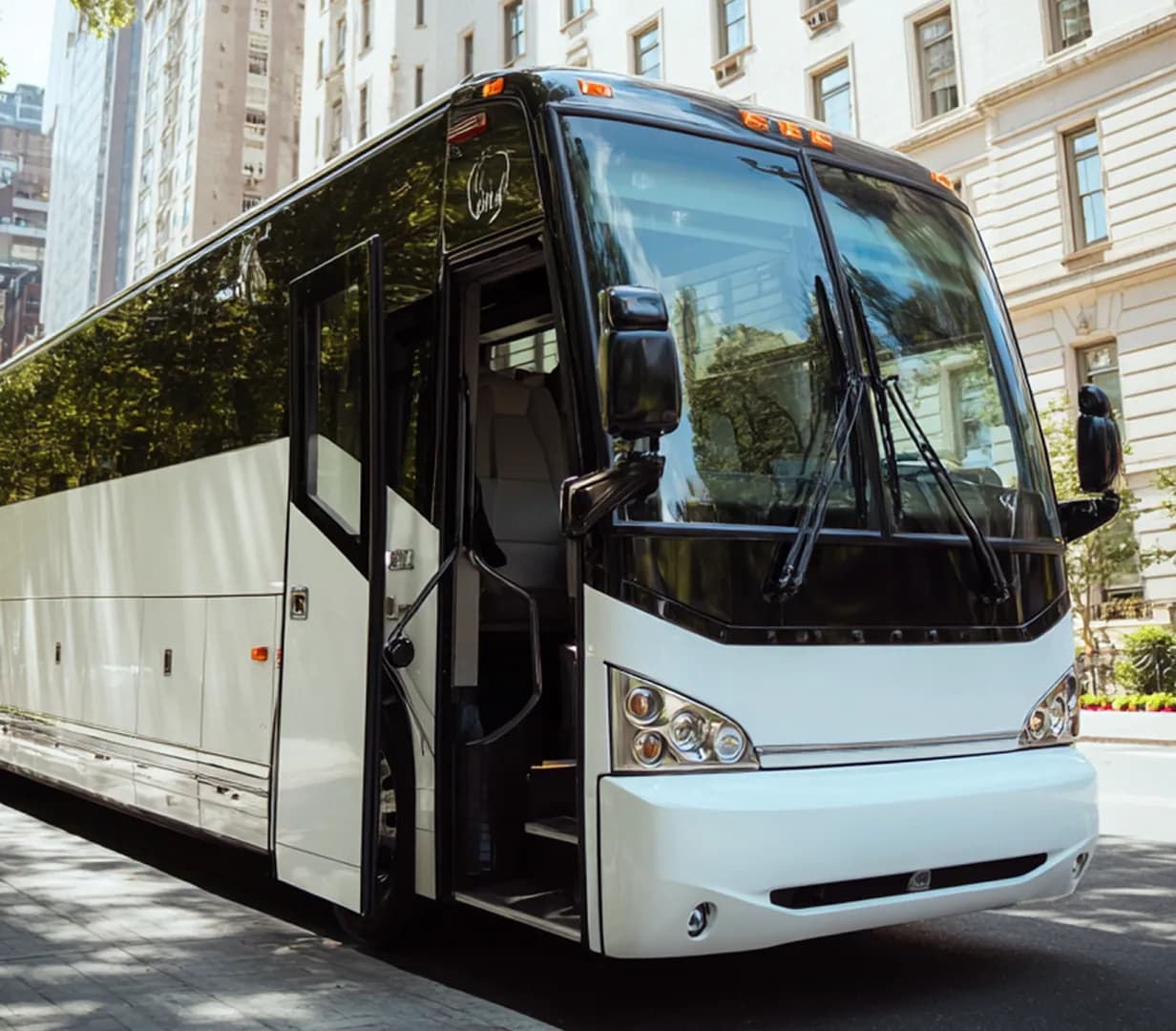 Coach parked on city street.