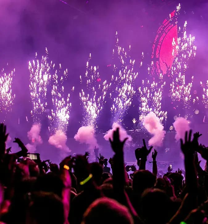 Concert crowd with pyrotechnics.