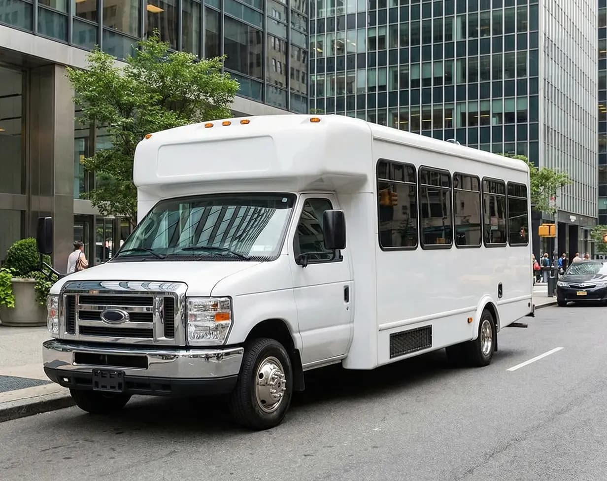 White minibus charter rental on New York city street.