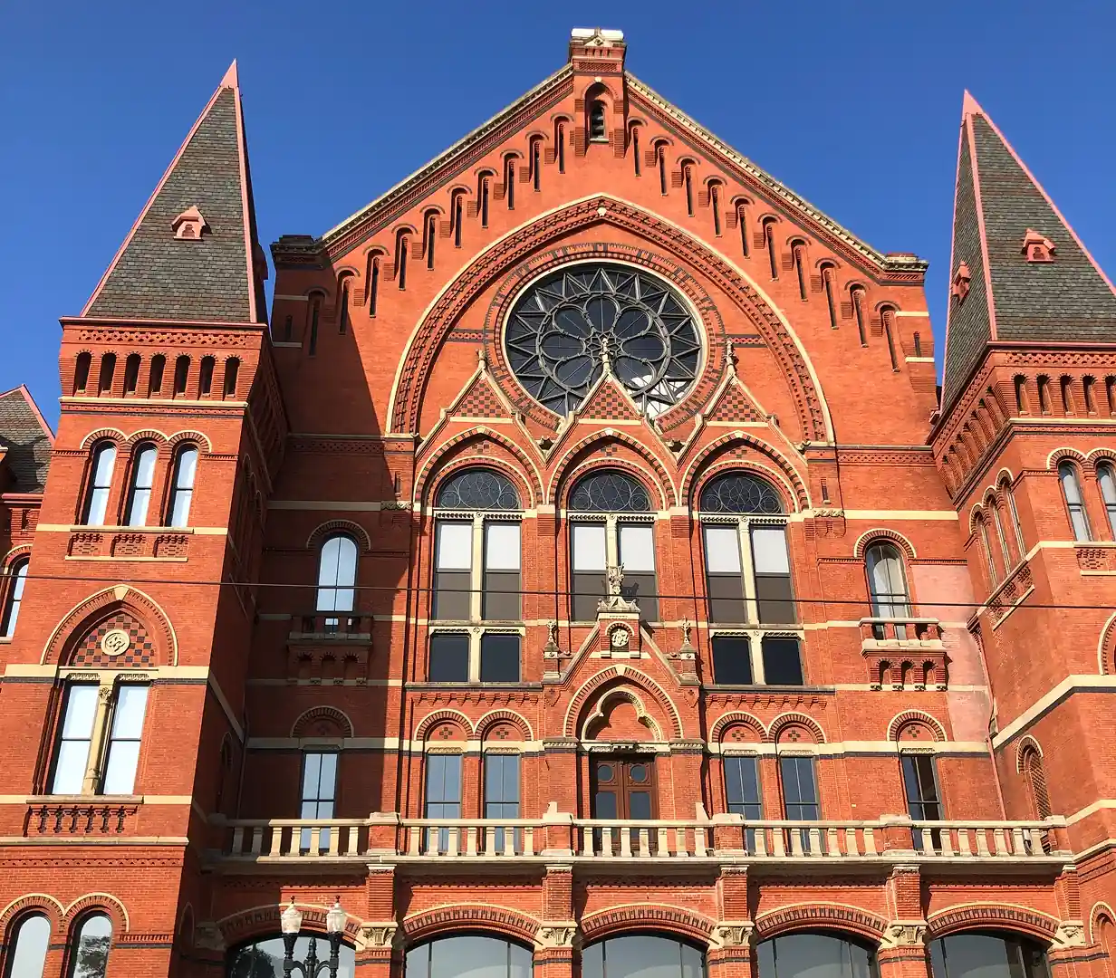 Gothic red brick facade and rose window of Music Hall in Cincinnati, Ohio, an Over-the-Rhine landmark on charter bus itineraries