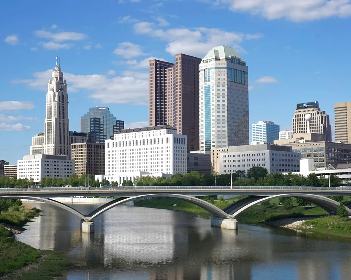 Downtown Columbus, Ohio skyline with the LeVeque Tower across the Scioto River, a common pickup area for charter bus groups