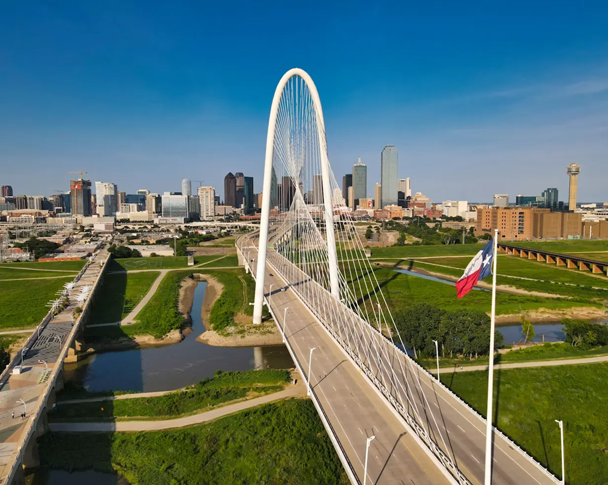 Aerial view of the Margaret Hunt Hill Bridge and downtown Dallas, Texas skyline, the routes charter bus groups ride into the city