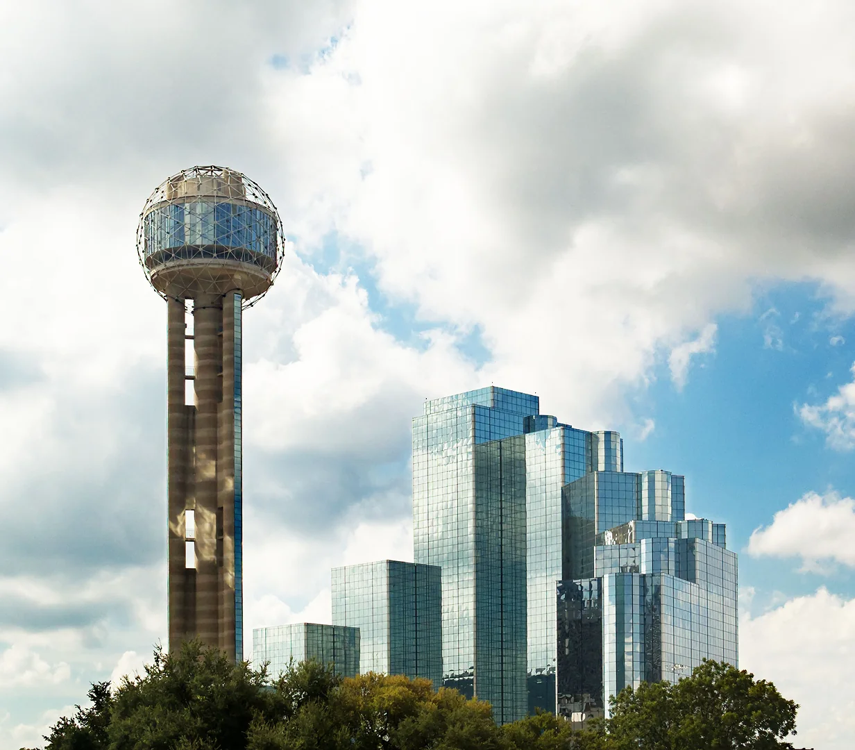 Reunion Tower beside the Hyatt Regency on the downtown Dallas skyline, a common pickup area for charter bus groups