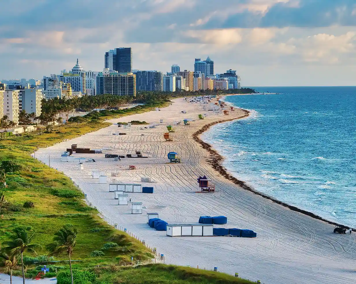 Aerial view of South Beach's white sand and the Miami, Florida skyline, a hotel pickup area for charter bus groups