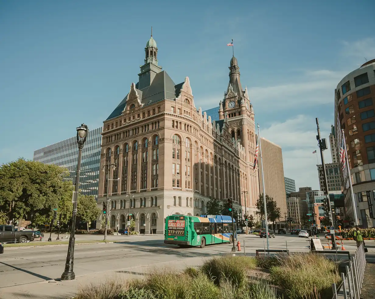 Milwaukee, Wisconsin City Hall clock tower with a charter bus on the downtown street below, a common pickup area for group tours
