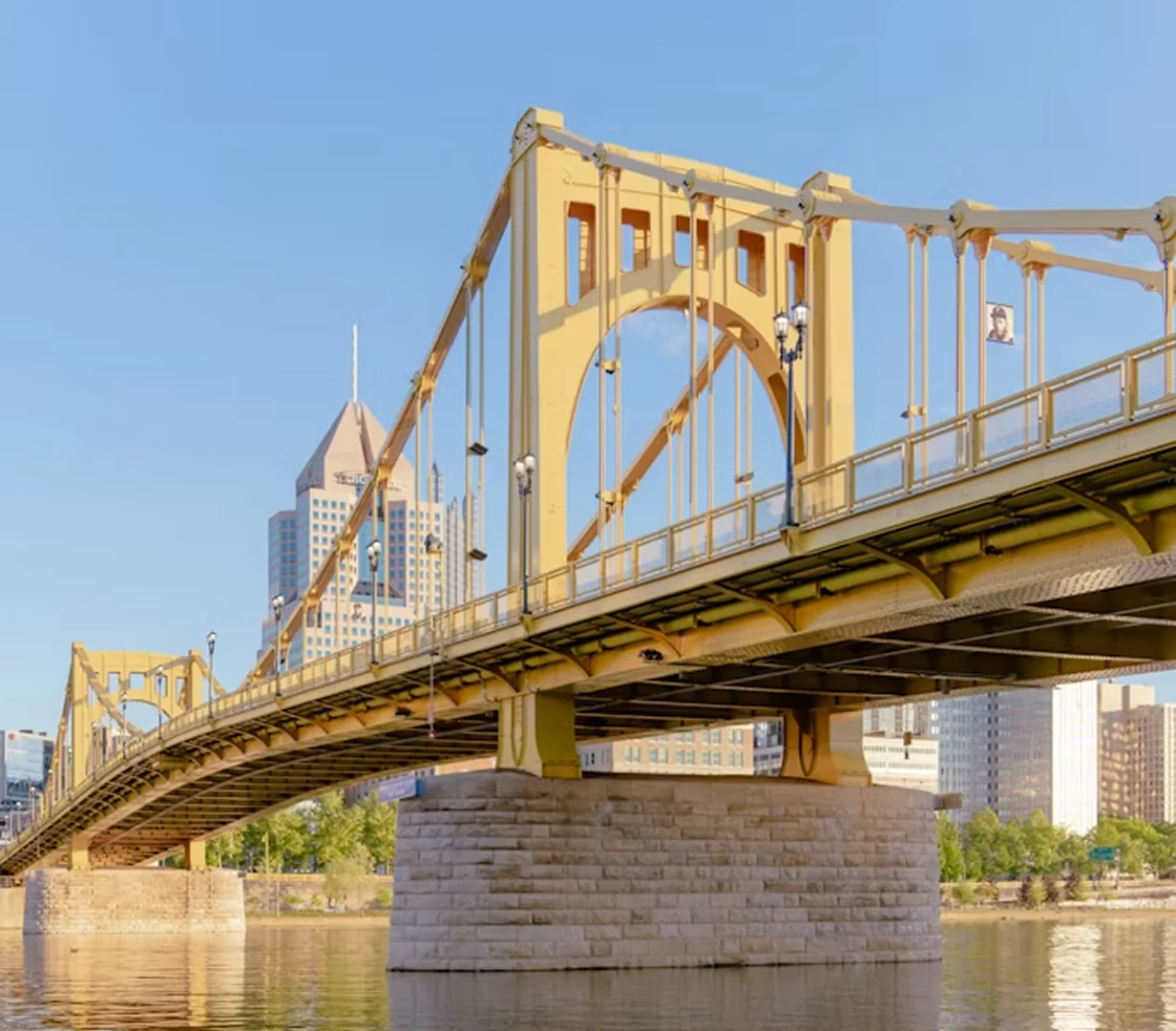 Yellow bridge over the river into downtown Pittsburgh, one of the crossings charter bus operators route around