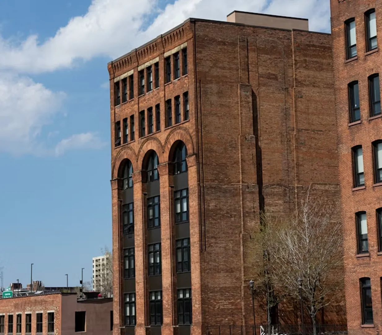 Historic brick warehouse with arched windows in downtown Rochester, New York, on the streets charter bus operators run daily