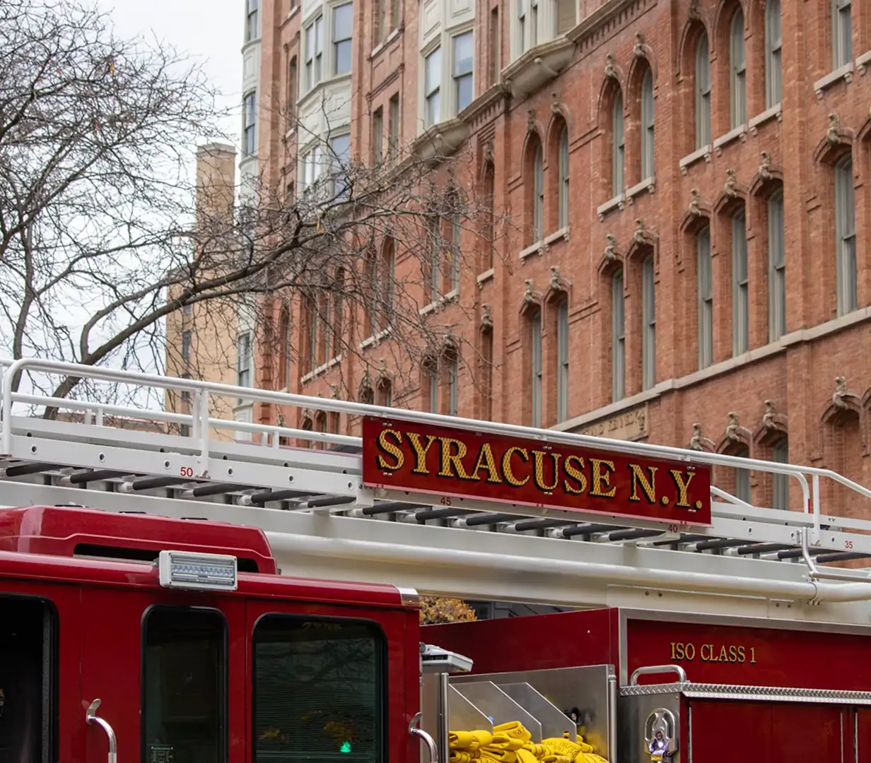 Fire truck outside a historic brick fire station in downtown Syracuse, New York, on the streets charter bus operators navigate during the I-81 rebuild