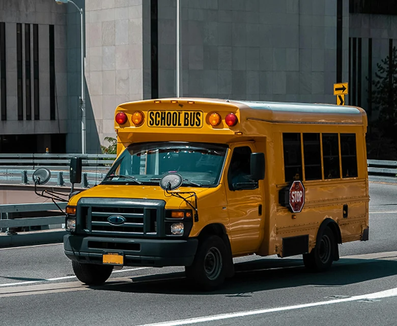 Yellow school bus at curb.