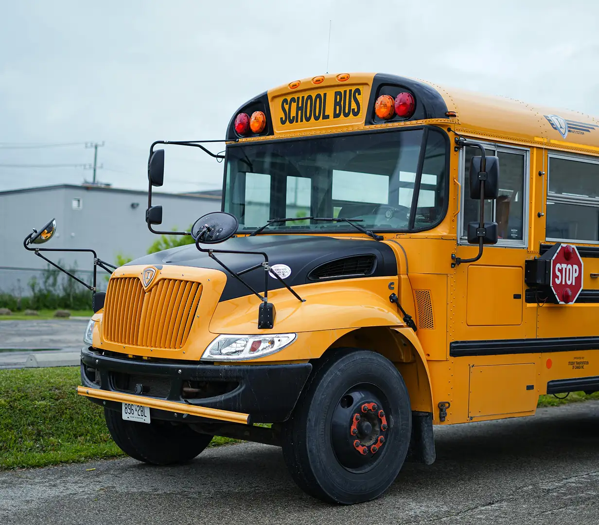 Yellow school bus on city street.